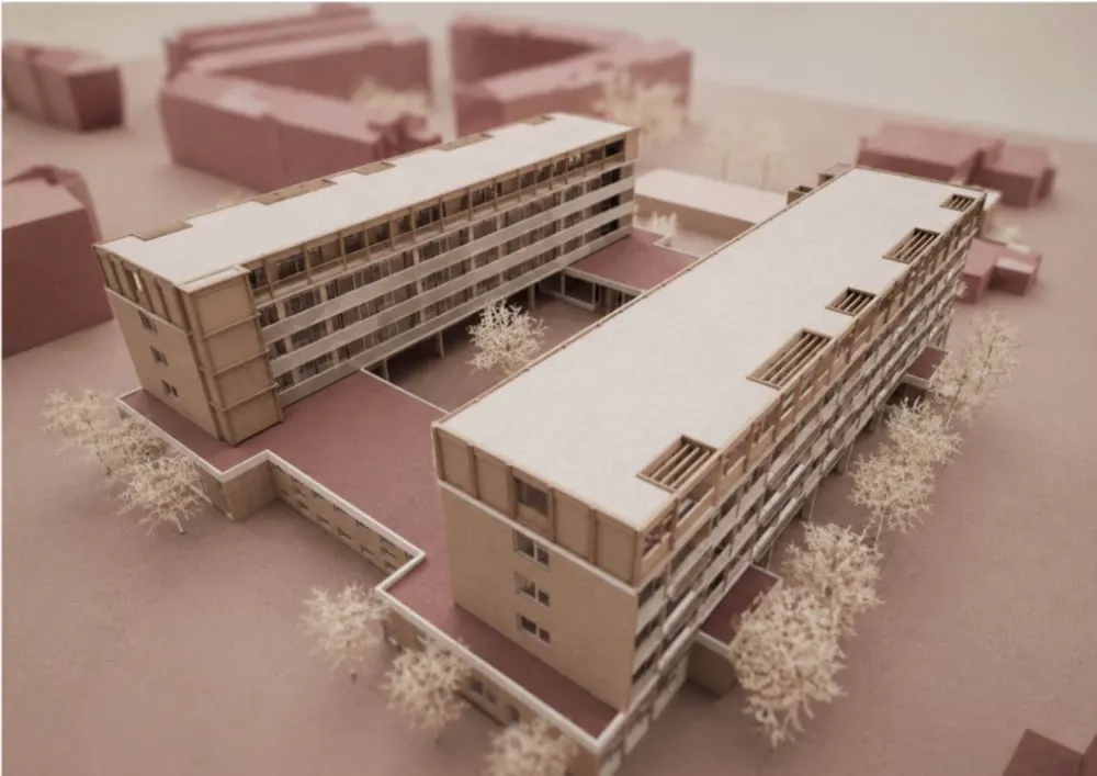 Een maquette van een woongebouw met een nieuwe laag op het dak